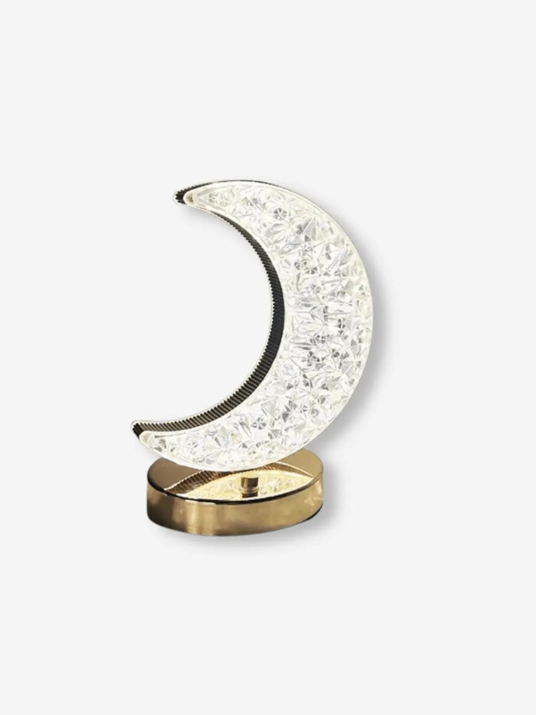 lampe de chevet en forme de croissant de lune en cristal sur un socle dore