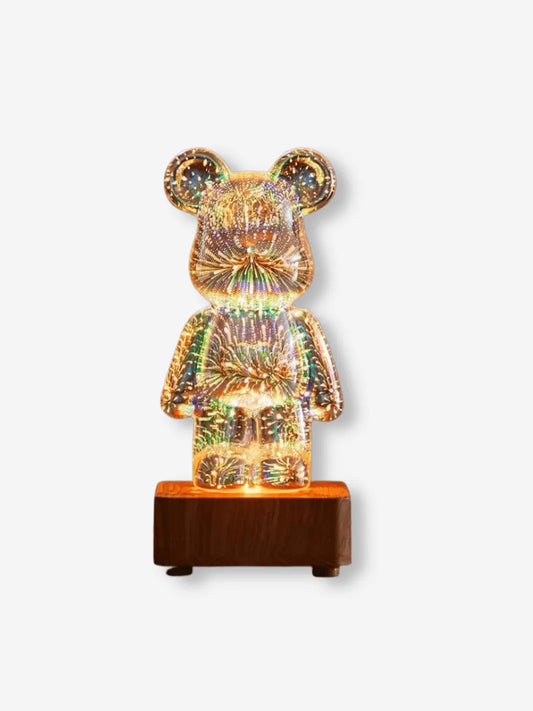 lampe de chevet en verre et bois transparente pour enfant representant un ourson qui s illumine de l interieur en feux d artifice sur un socle en bois